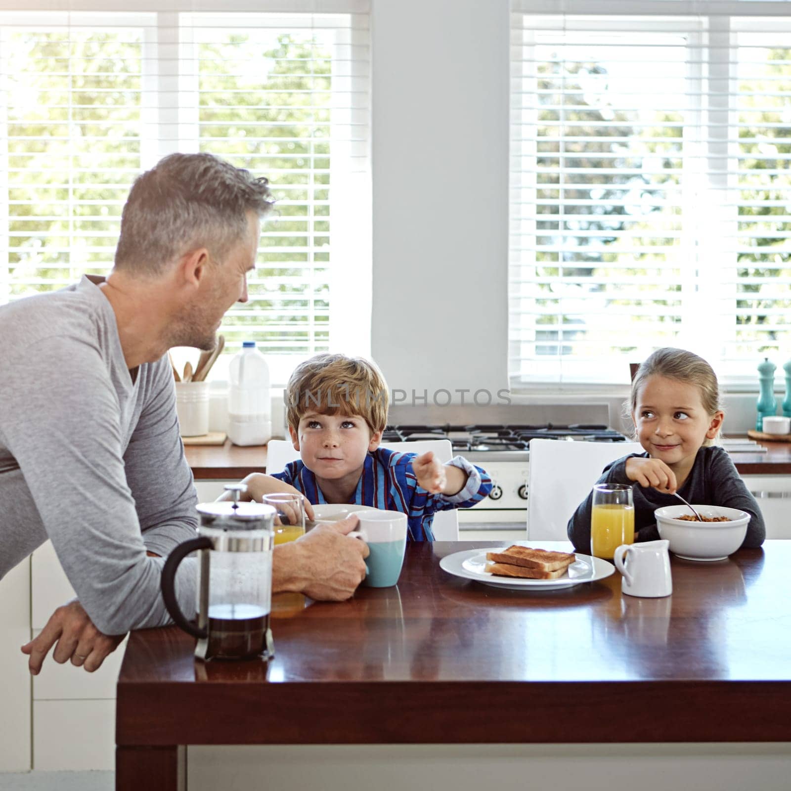 Theyre all fun of smiles. a family having breakfast together at home