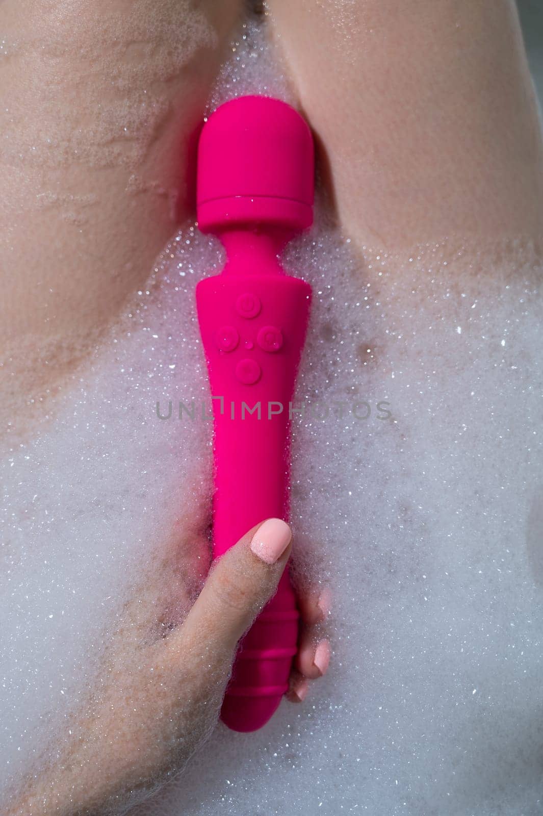 Woman lies in a bubble bath and uses a vibrator. by mrwed54