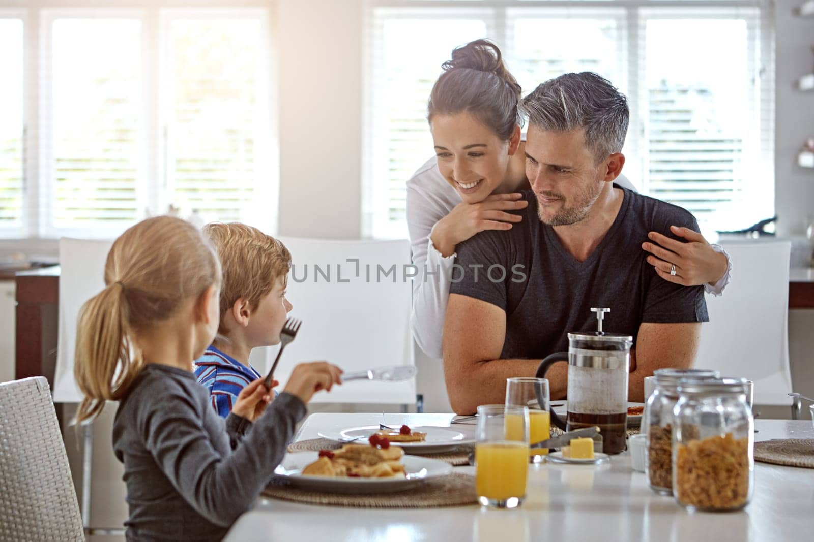 Nothing beats family mealtime. a family having breakfast together. by YuriArcurs