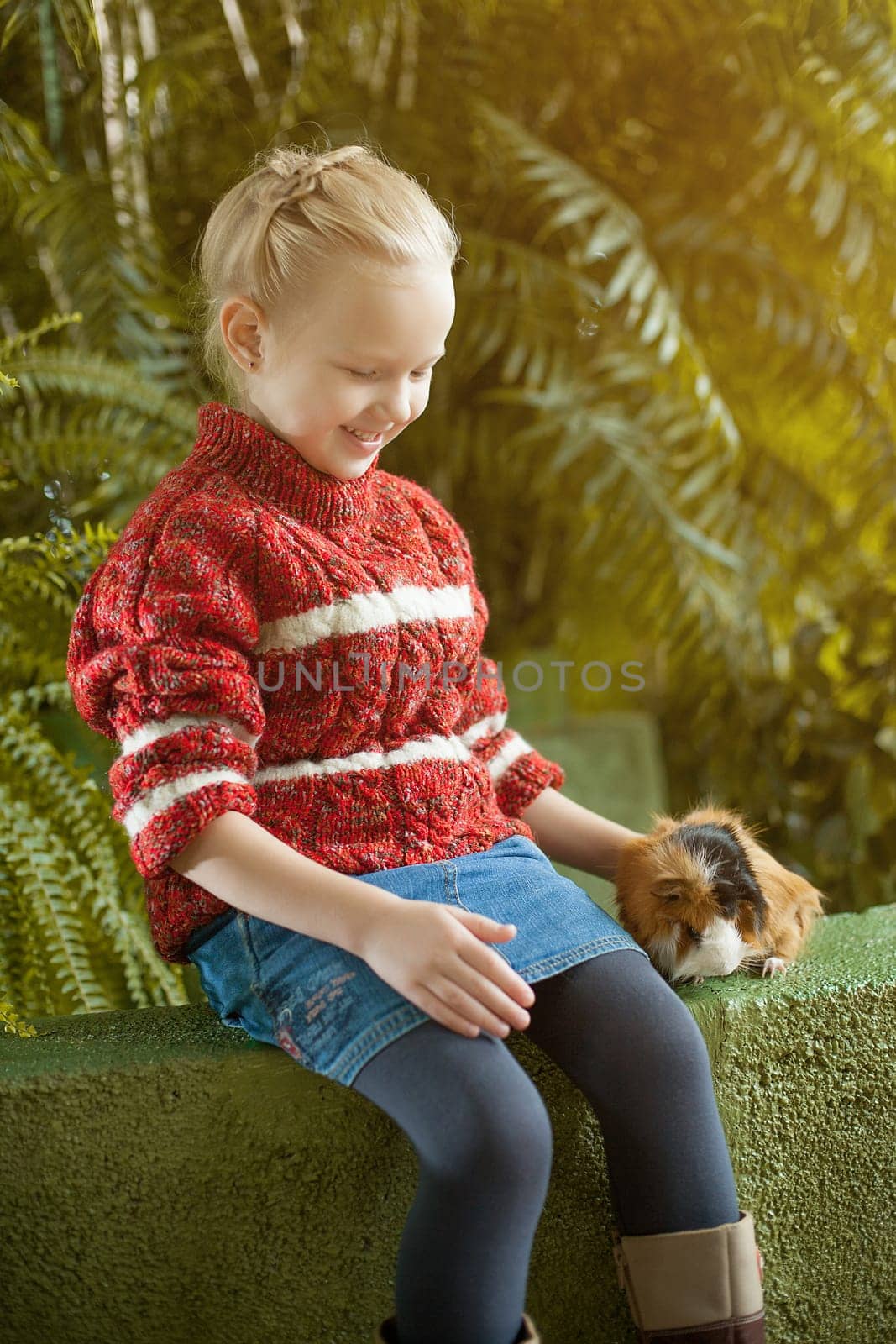Image of smiling girl posing with cute cavy, close-up