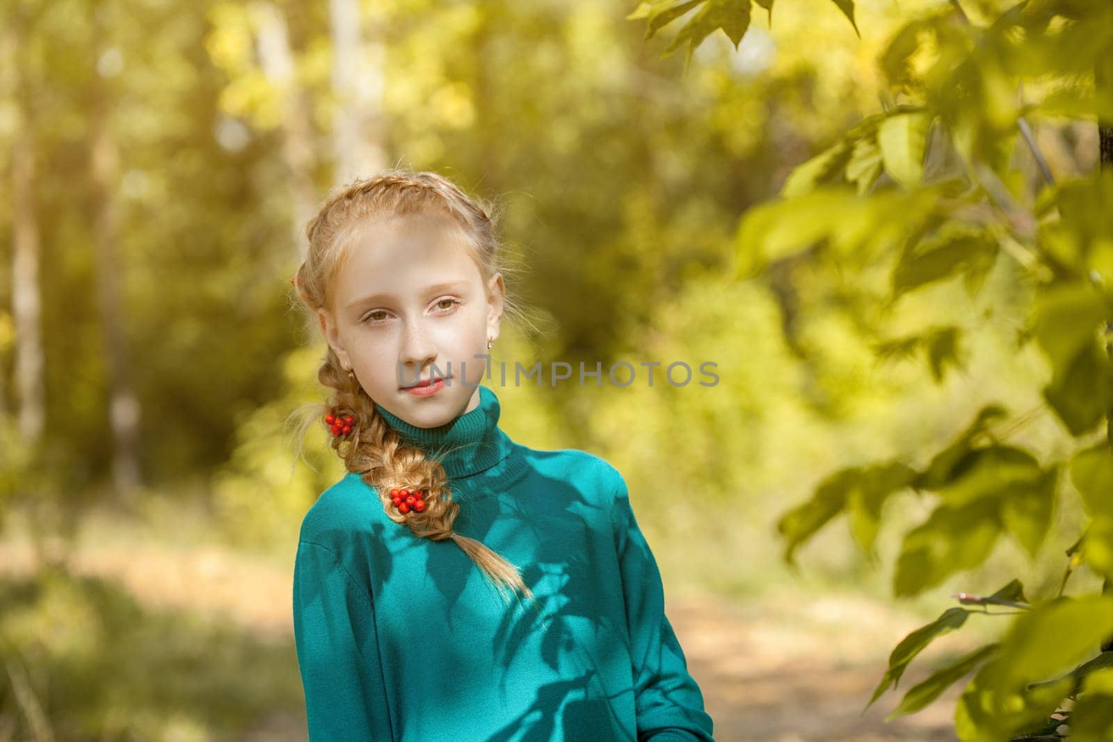 Portrait of charming freckled girl with pigtail, close-up
