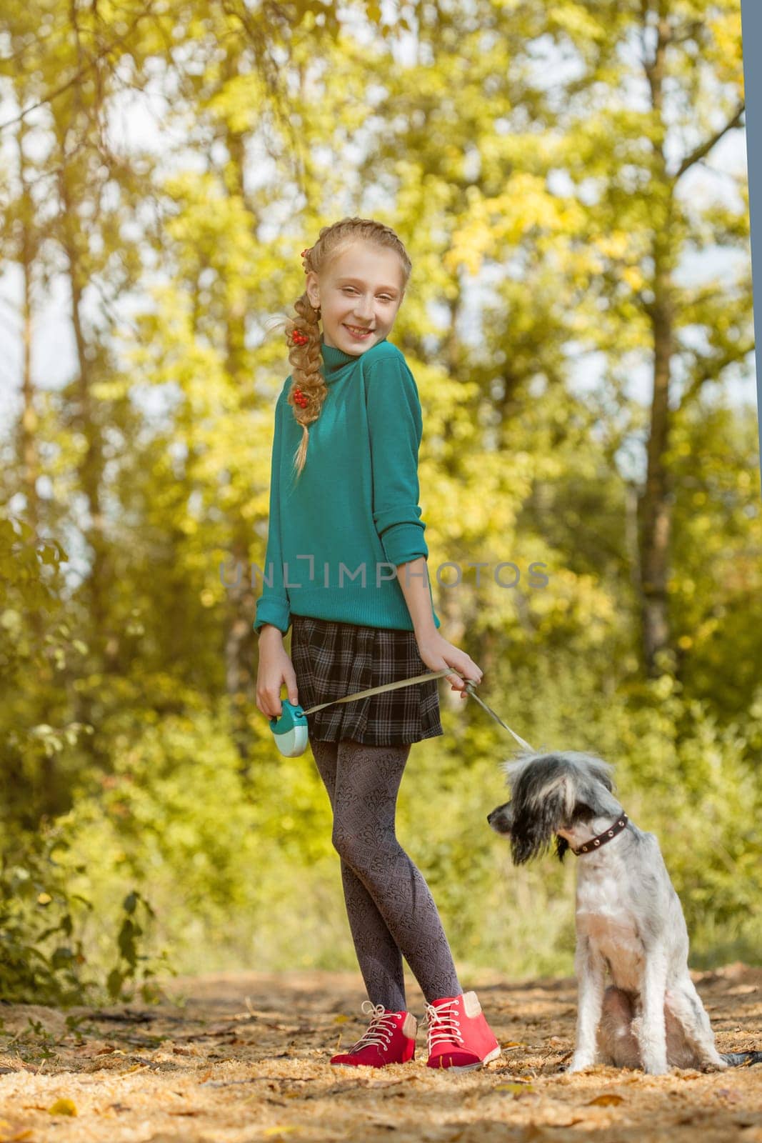 Image of playful little girl posing with puppy, close-up
