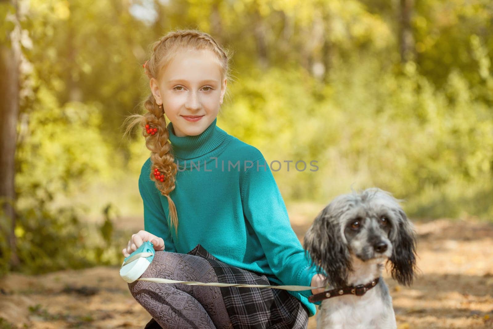 Portrait of cute smiling freckled girl posing with dog