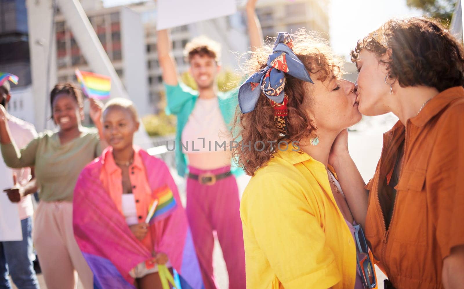 Love, kiss and couple of friends in city with rainbow flag for support, queer celebration and relationship. Diversity, lgbtq community and group of people enjoy freedom, happiness and pride identity.