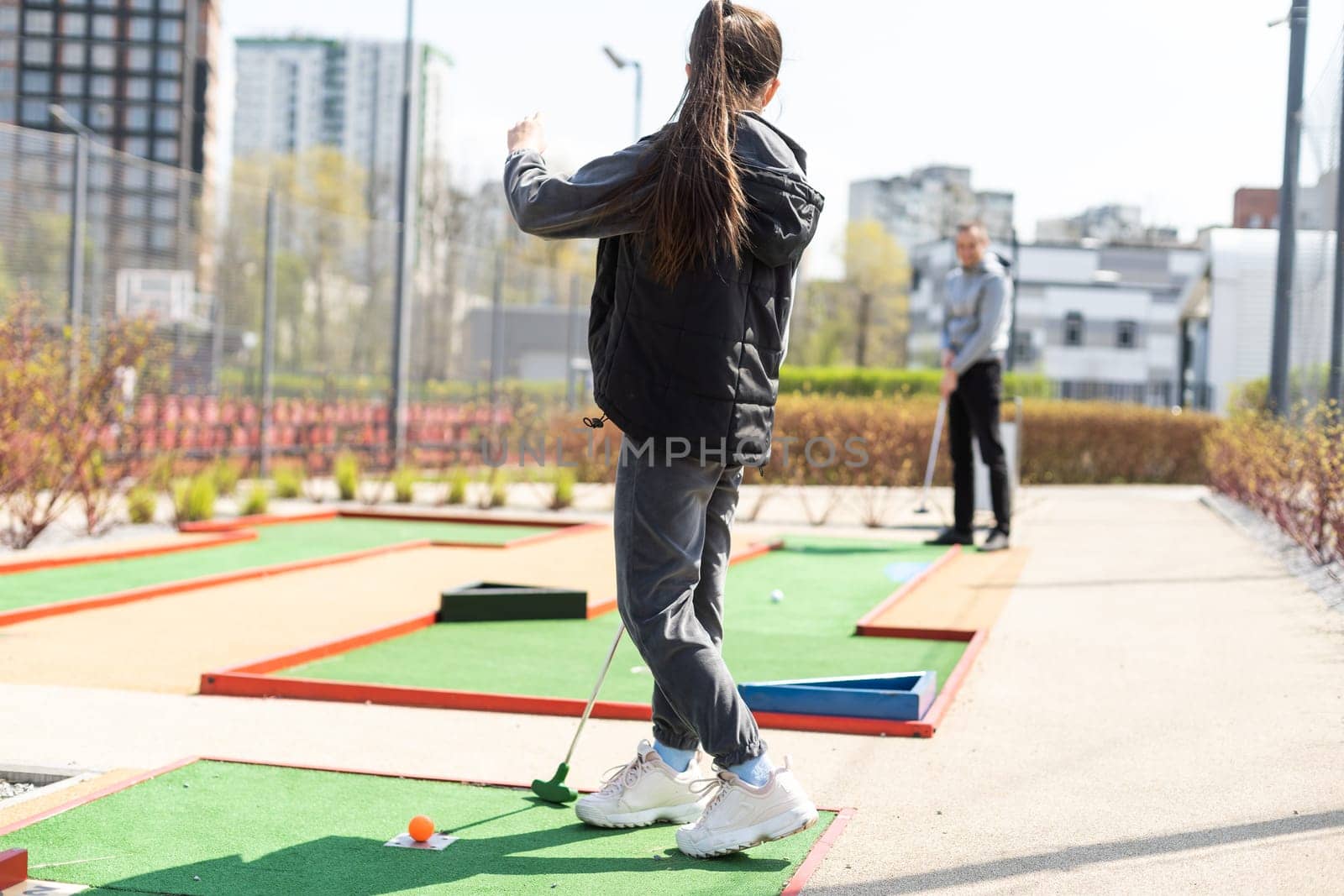 Mini-golf ball on artificial grass. Summer season game.