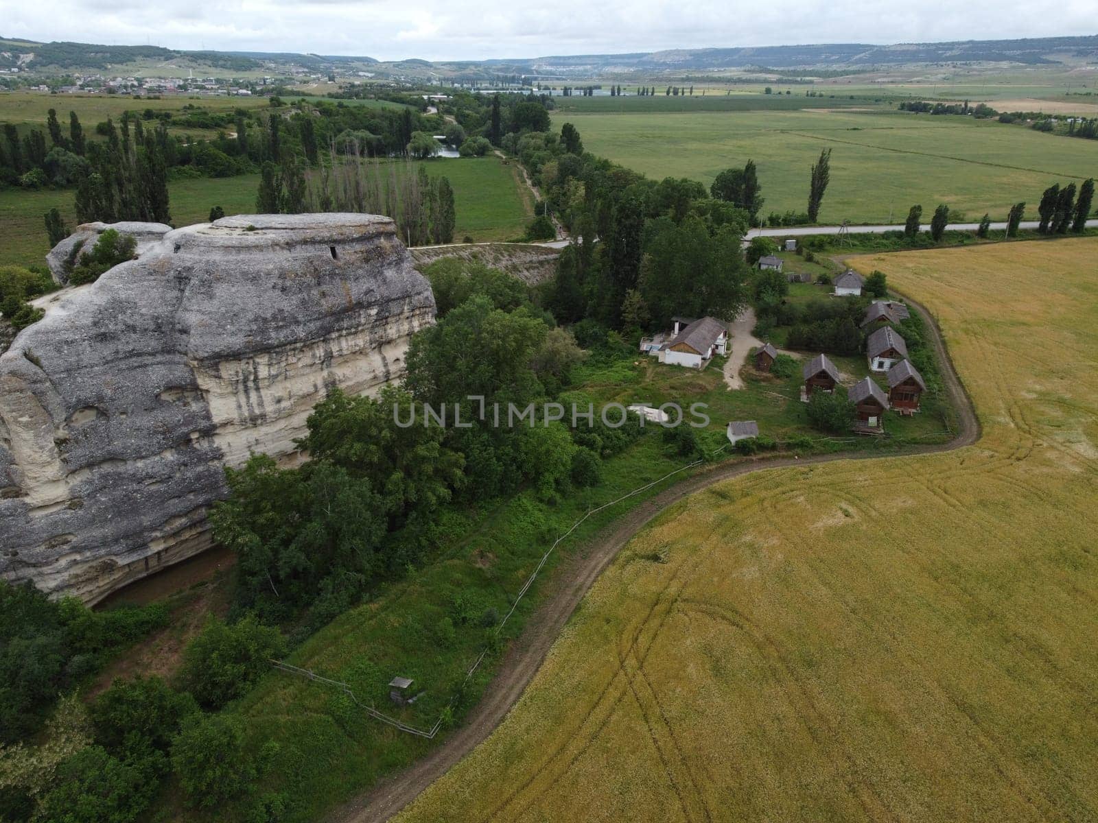 lush green farm field with rocky cliffs in the distance. The video highlights the beauty of rural areas and the agricultural process.