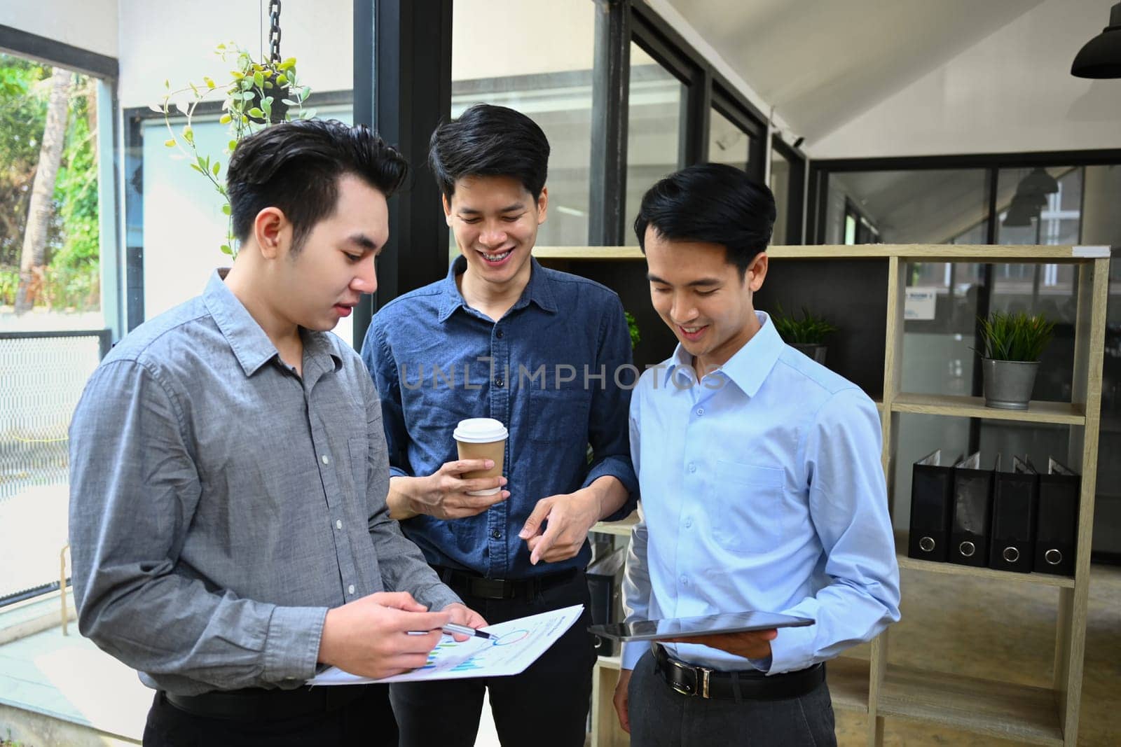 Image of business team discussing startup project, sharing business ideas during coffee break.