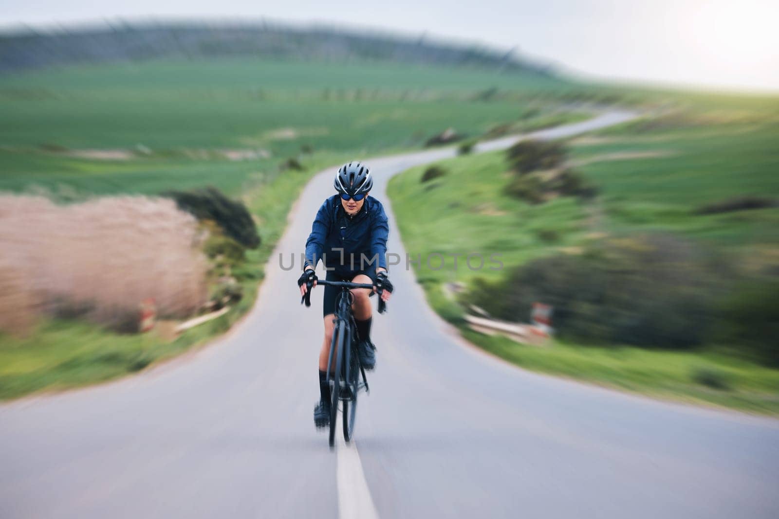 Fitness, race and cycling with woman in road for training, competition or championship. Workout, sports and triathlon with female cyclist riding on bike and fast for freedom, exercise and motion blur.
