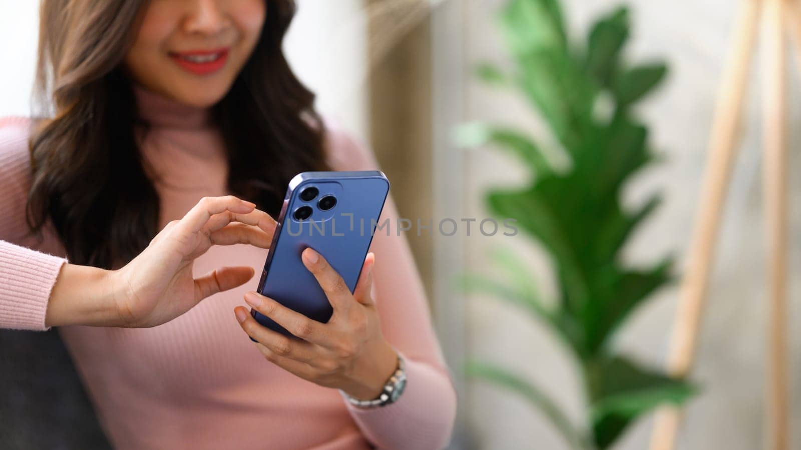 Happy young woman texting messaging on smartphone. Lifestyle, communicating and technology concept by prathanchorruangsak