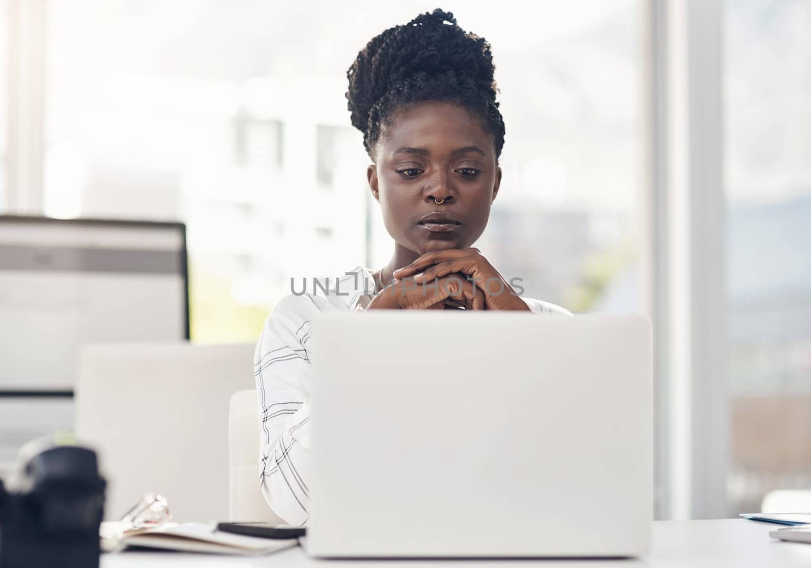 Spend time working on your passion. an attractive young businesswoman sitting alone in her office and looking contemplative while using her laptop