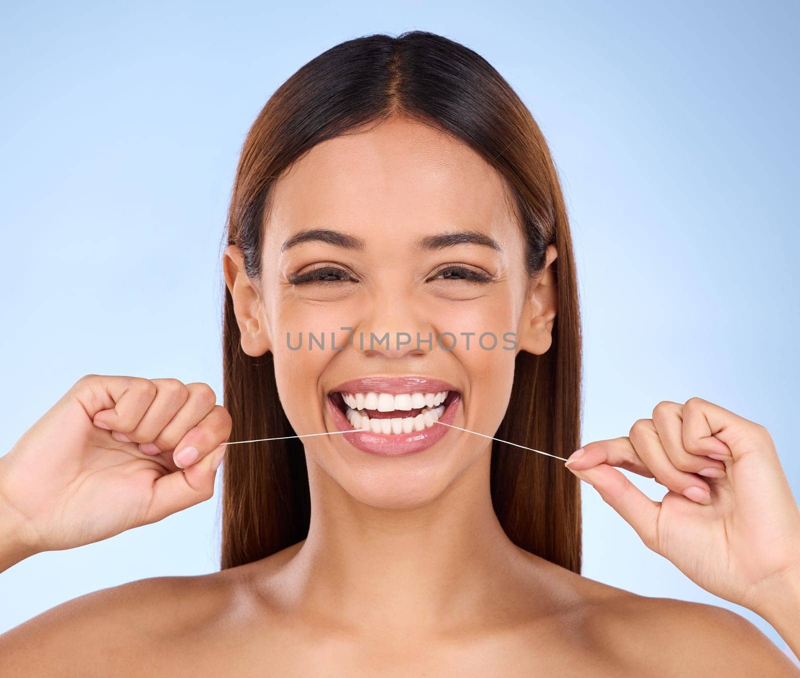 Dental floss, happy portrait and woman smile with teeth hygiene, healthcare and wellness treatment. Isolated, blue background and studio with a female feeling beauty from a clean mouth with self care.