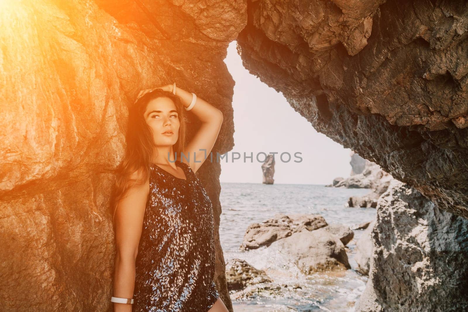 Woman summer travel sea. Happy tourist enjoy taking picture outdoors for memories. Woman traveler posing on the beach at sea surrounded by volcanic mountains, sharing travel adventure journey by panophotograph