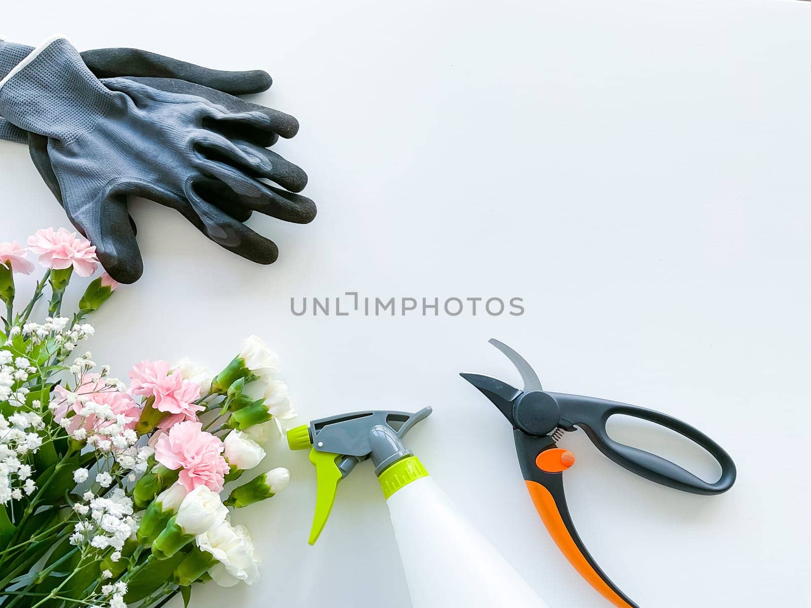 spray pink and white flowers with gardening tools by Lunnica