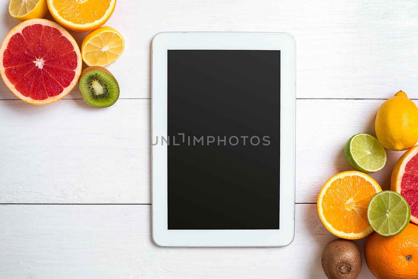 Fresh fruits with tape measure over white wooden background. Fitness concept. Flat lay. Top view. Copy space