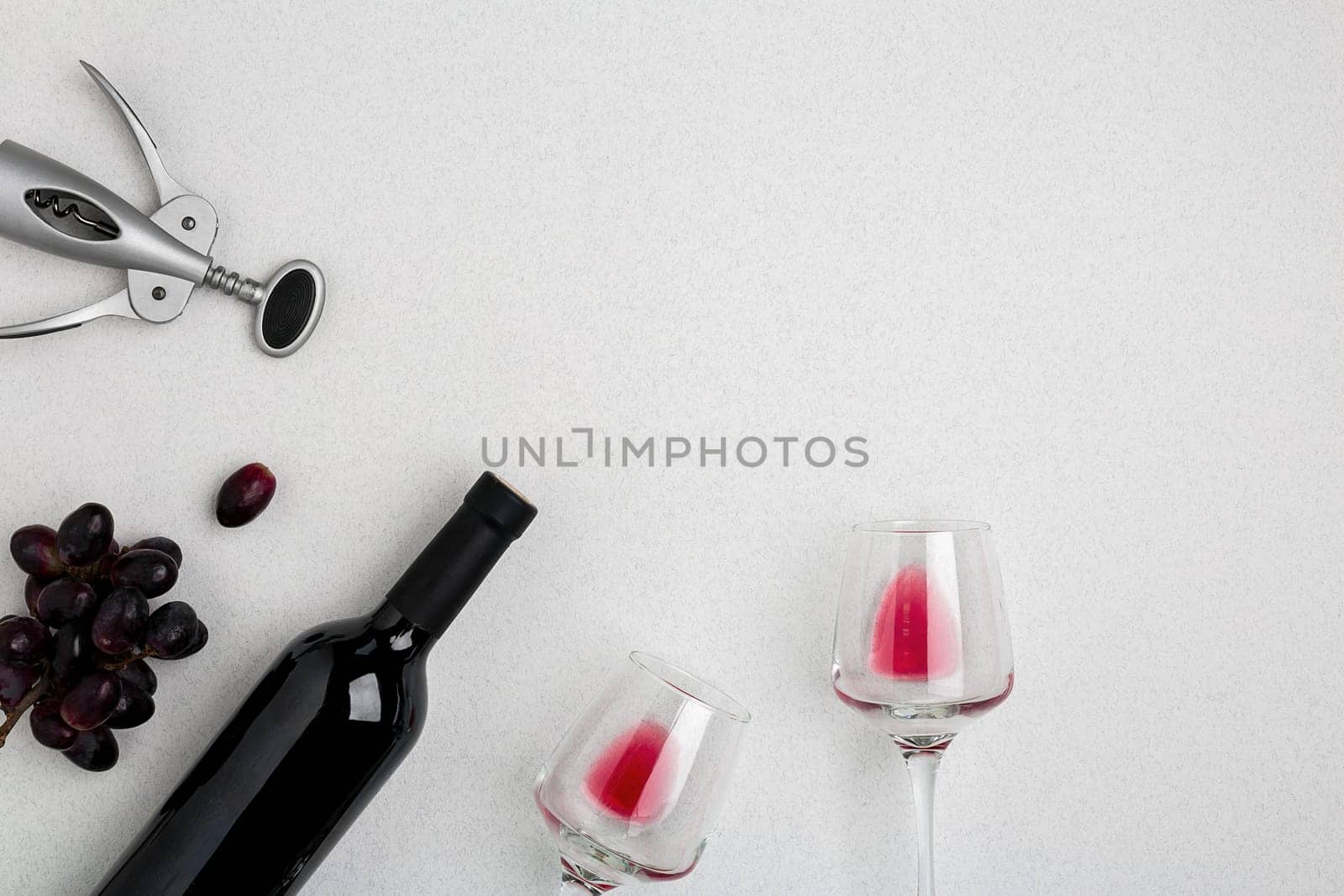Bottle of red wine with glasses on white background. Mock-up. Top view with copy space. Flat lay