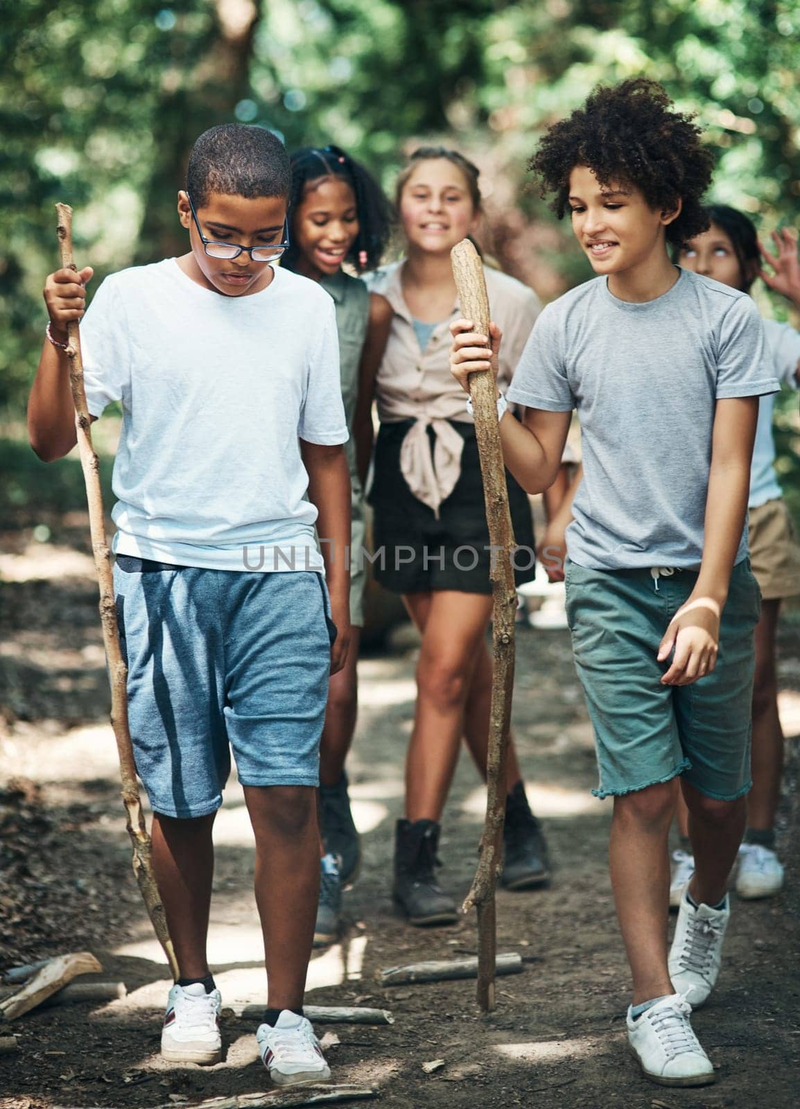 Camp time is adventure time. a group of teenagers exploring nature together at summer camp. by YuriArcurs
