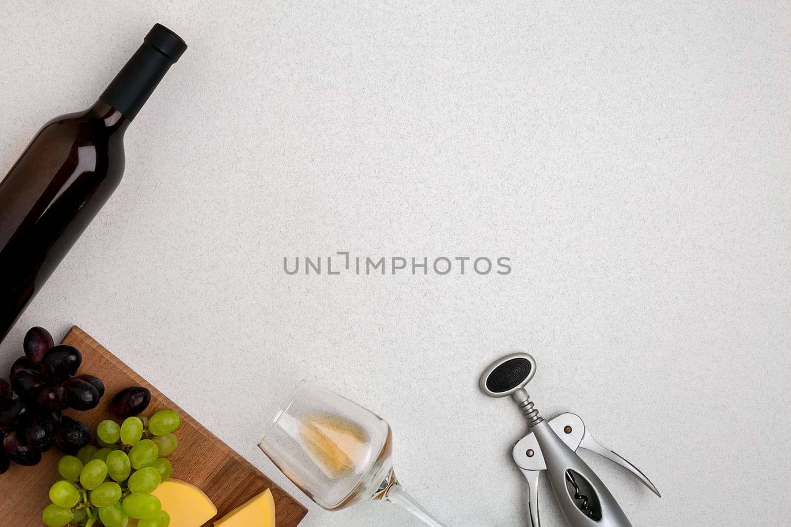Wine, glasses and corkscrew over white background. Top view with copy space