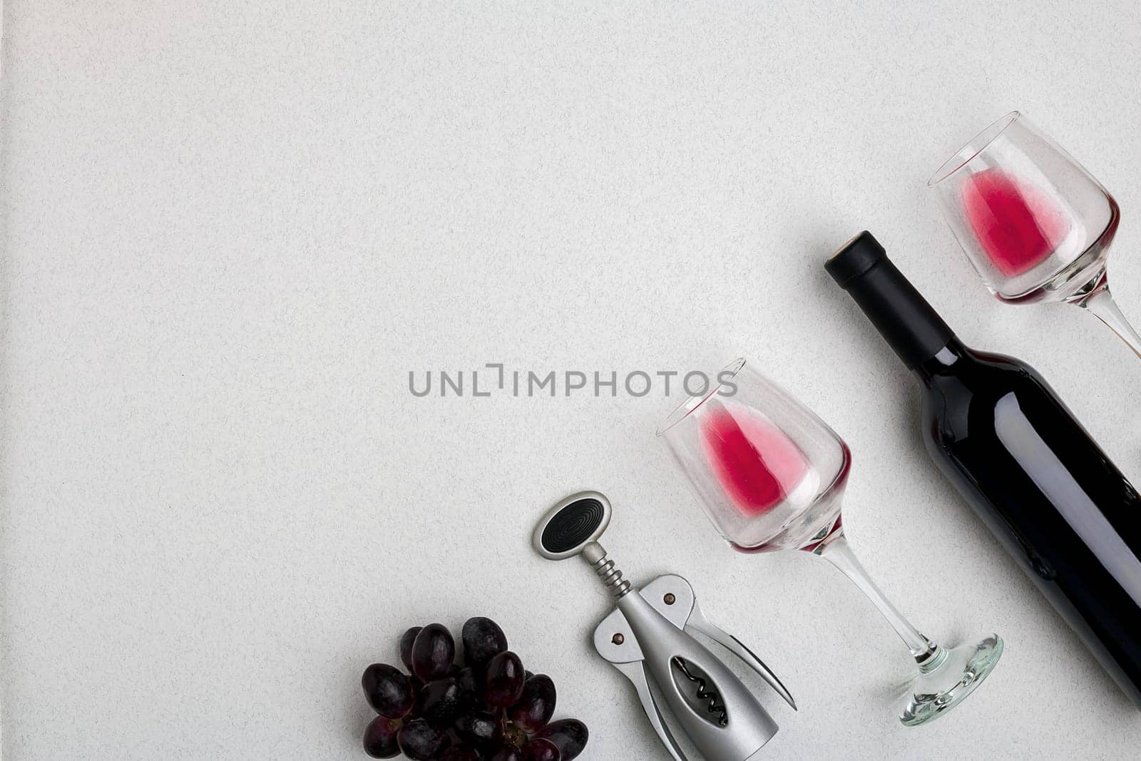 Wine, glasses and corkscrew over white background. Top view by nazarovsergey