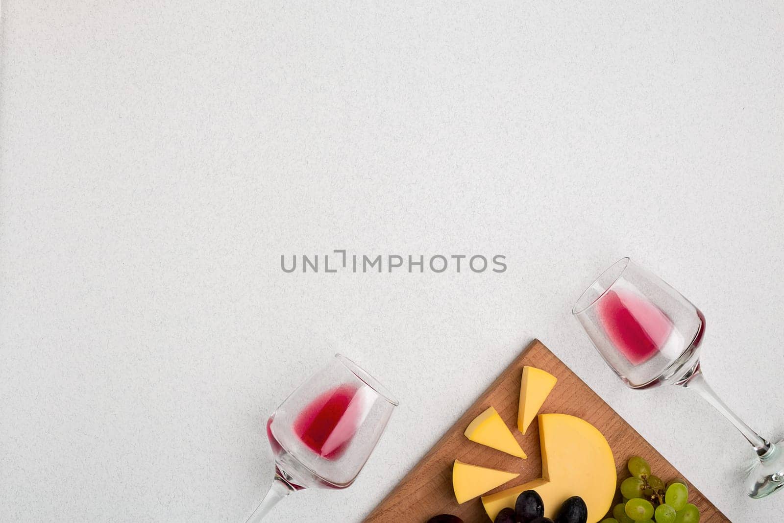 Glasses with red wine on white background from top view. Copy space