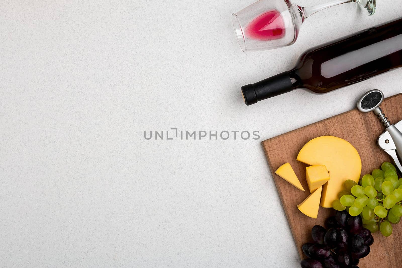 Wine, glasses and corkscrew over white background. Top view with copy space