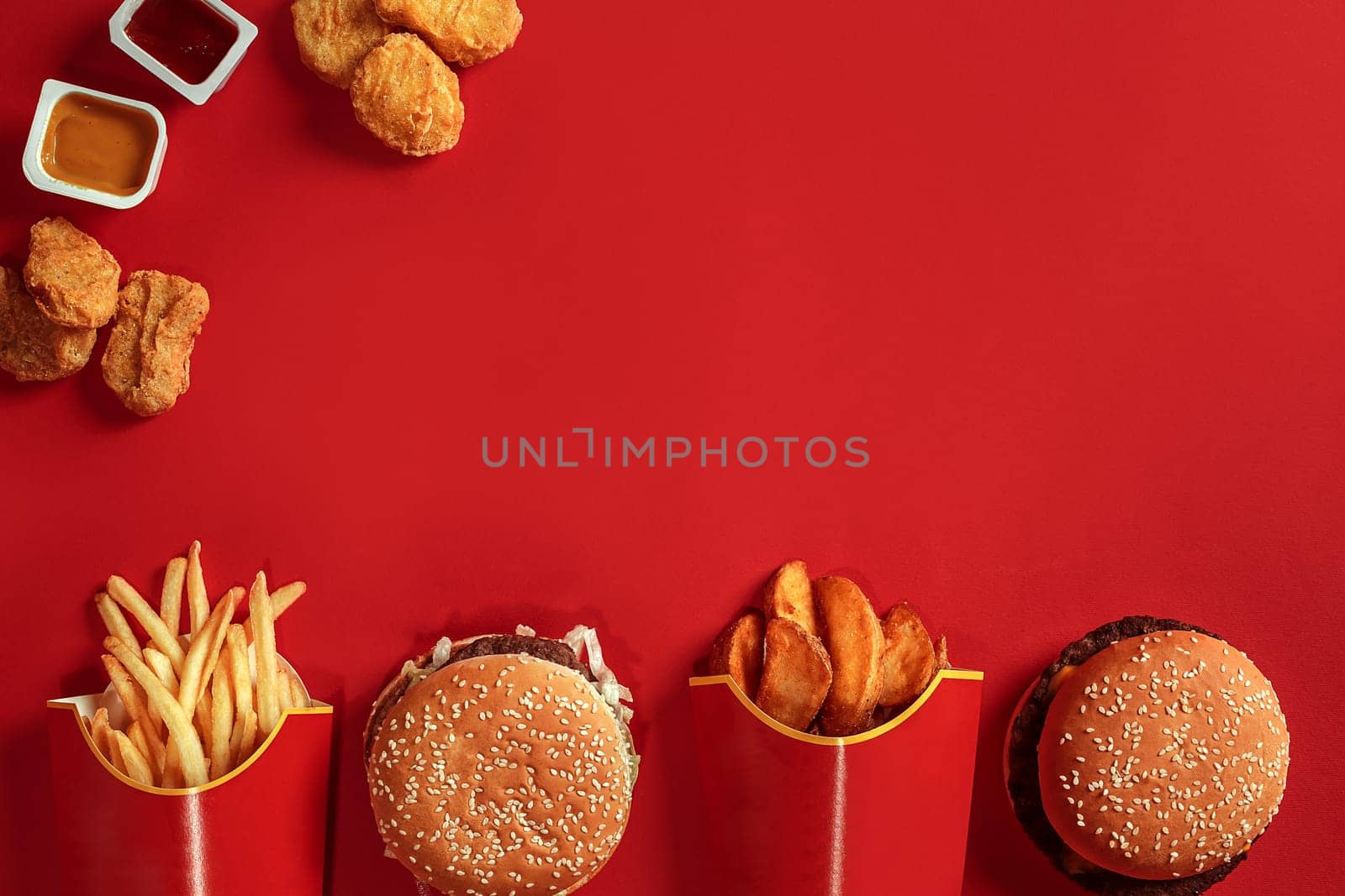 Burger and Chips. Hamburger and french fries in red paper box. Fast food on red background. by nazarovsergey
