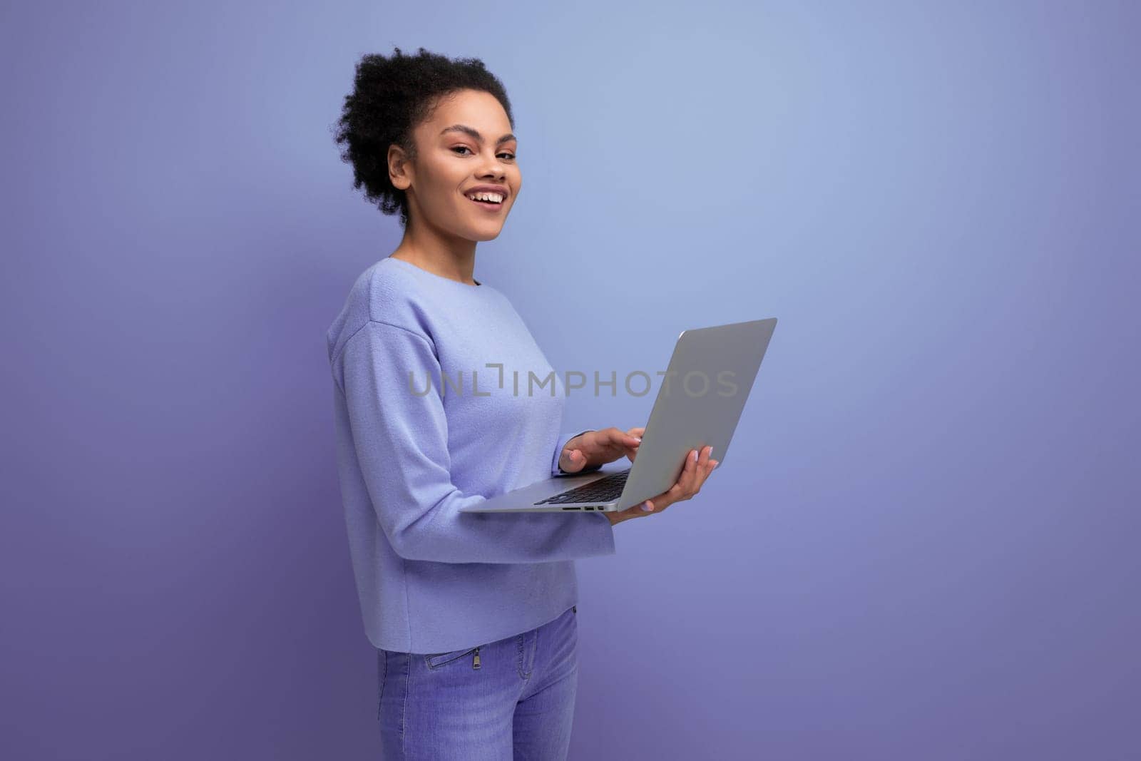 successful young afro hair brunette business woman working using laptop.