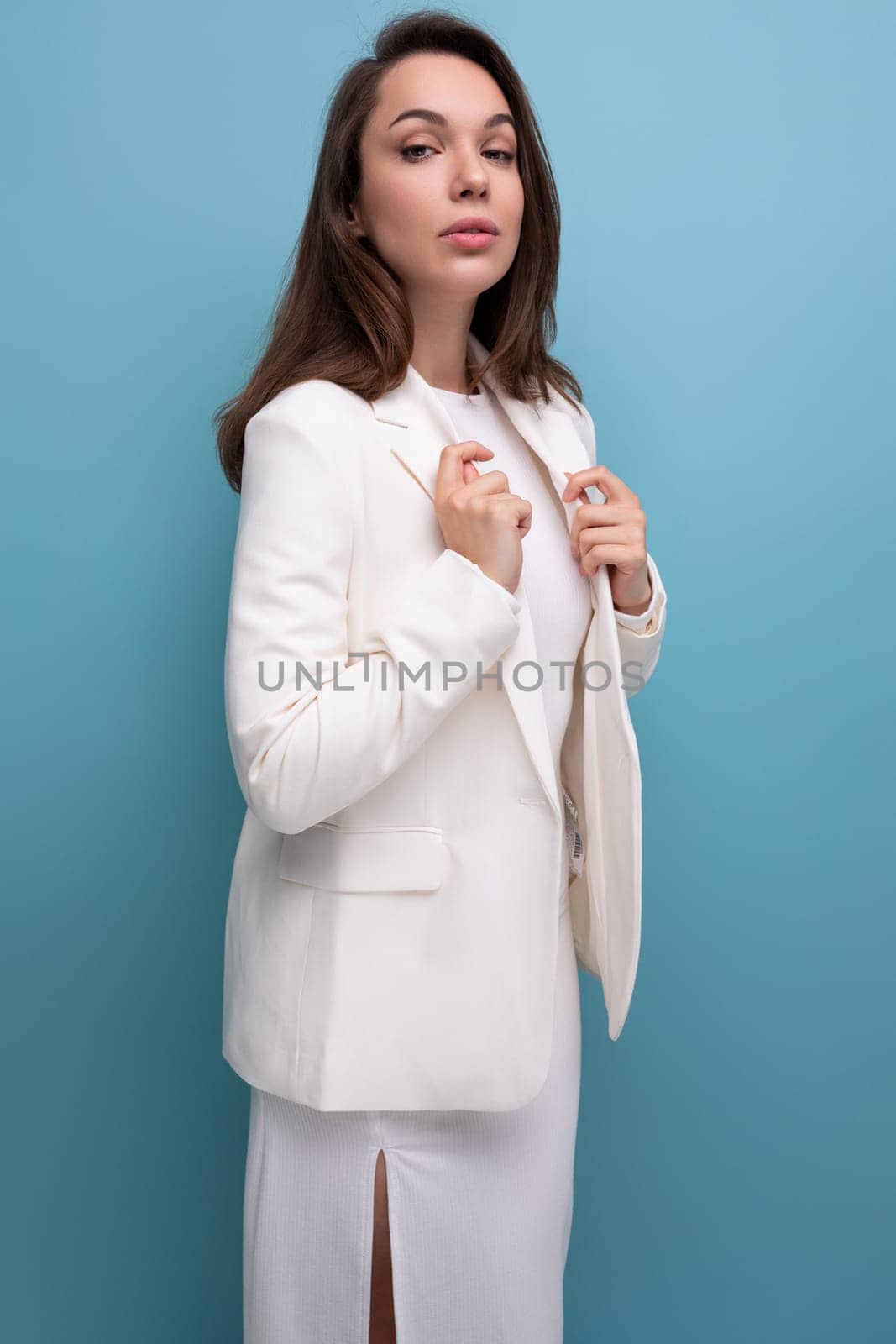 positive confident dark-haired woman in white outfit.