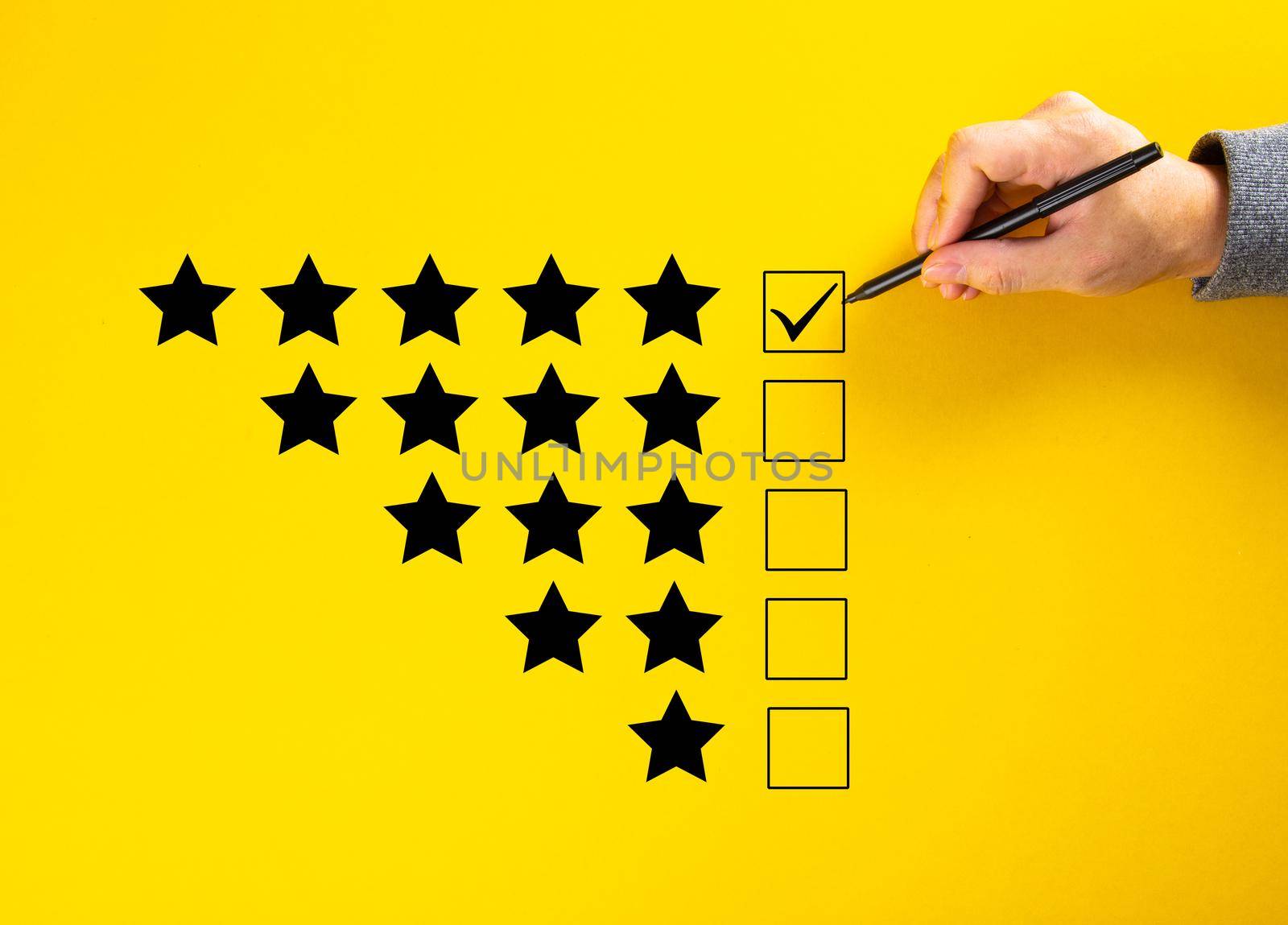 Hand putting a check on the 5 star rating. Survey Concept