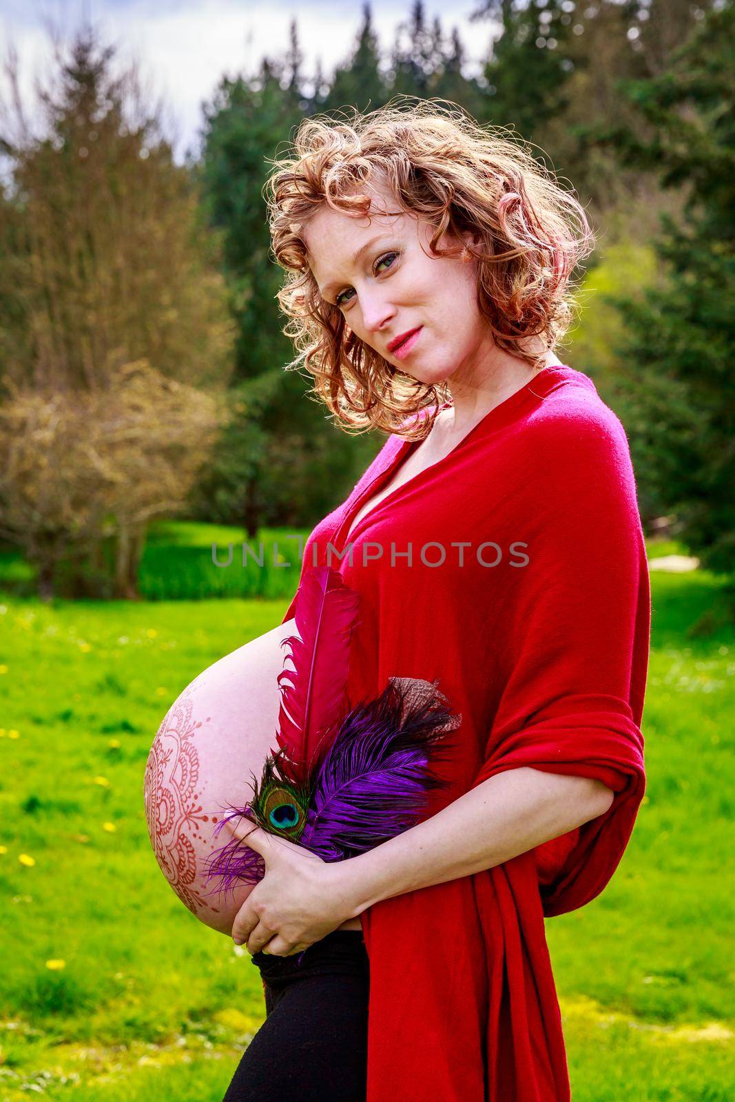 Young beautiful woman with pregnant belly showing.