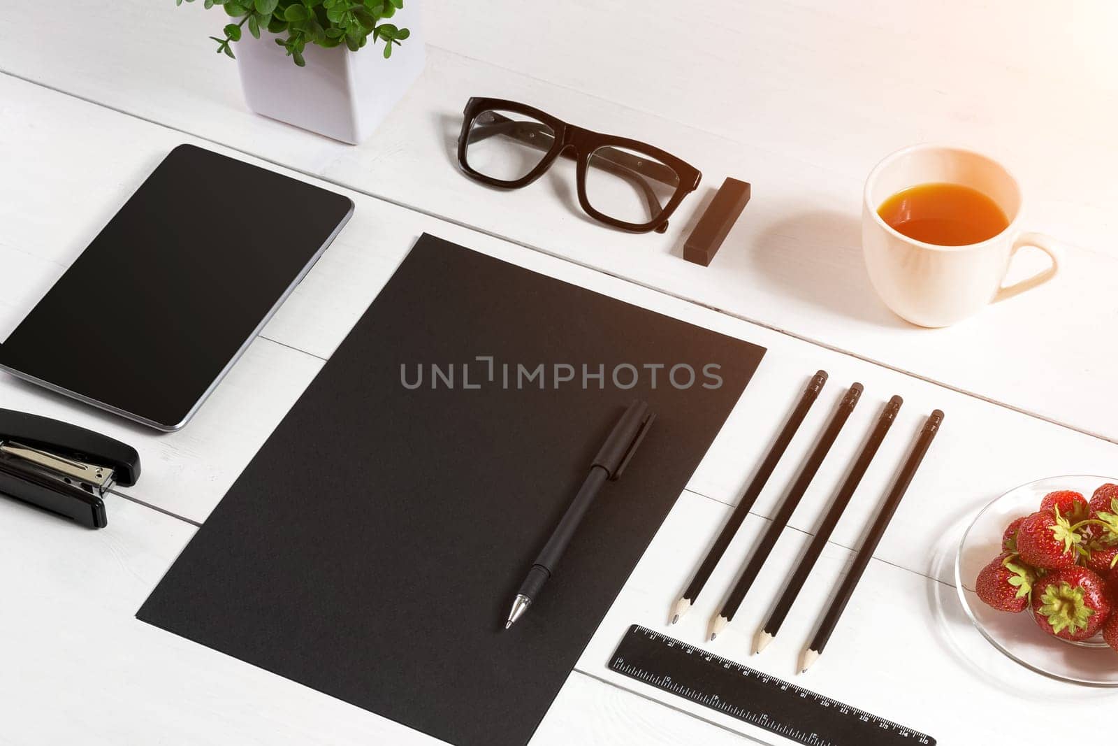 Modern workplace with digital tablet computer and mobile phone, cup of coffee, pen and empty sheet of paper. by nazarovsergey