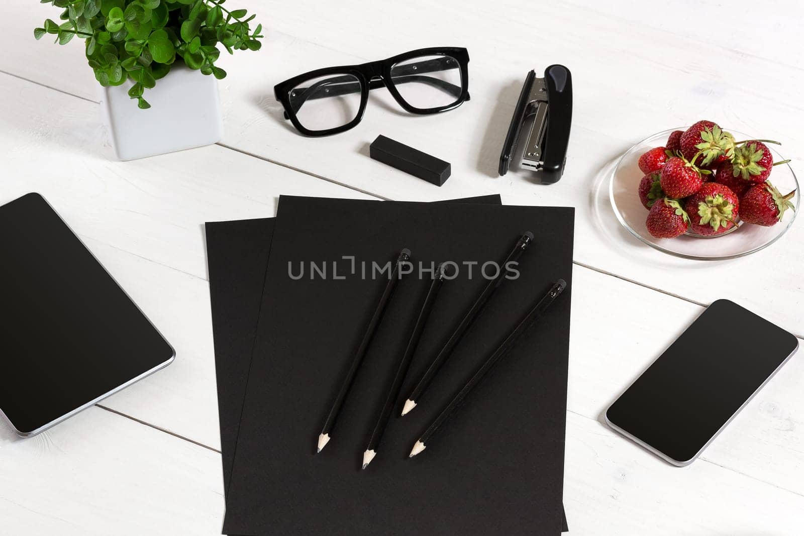 Modern workplace with digital tablet computer and mobile phone, cup of coffee, pen and empty sheet of paper. by nazarovsergey