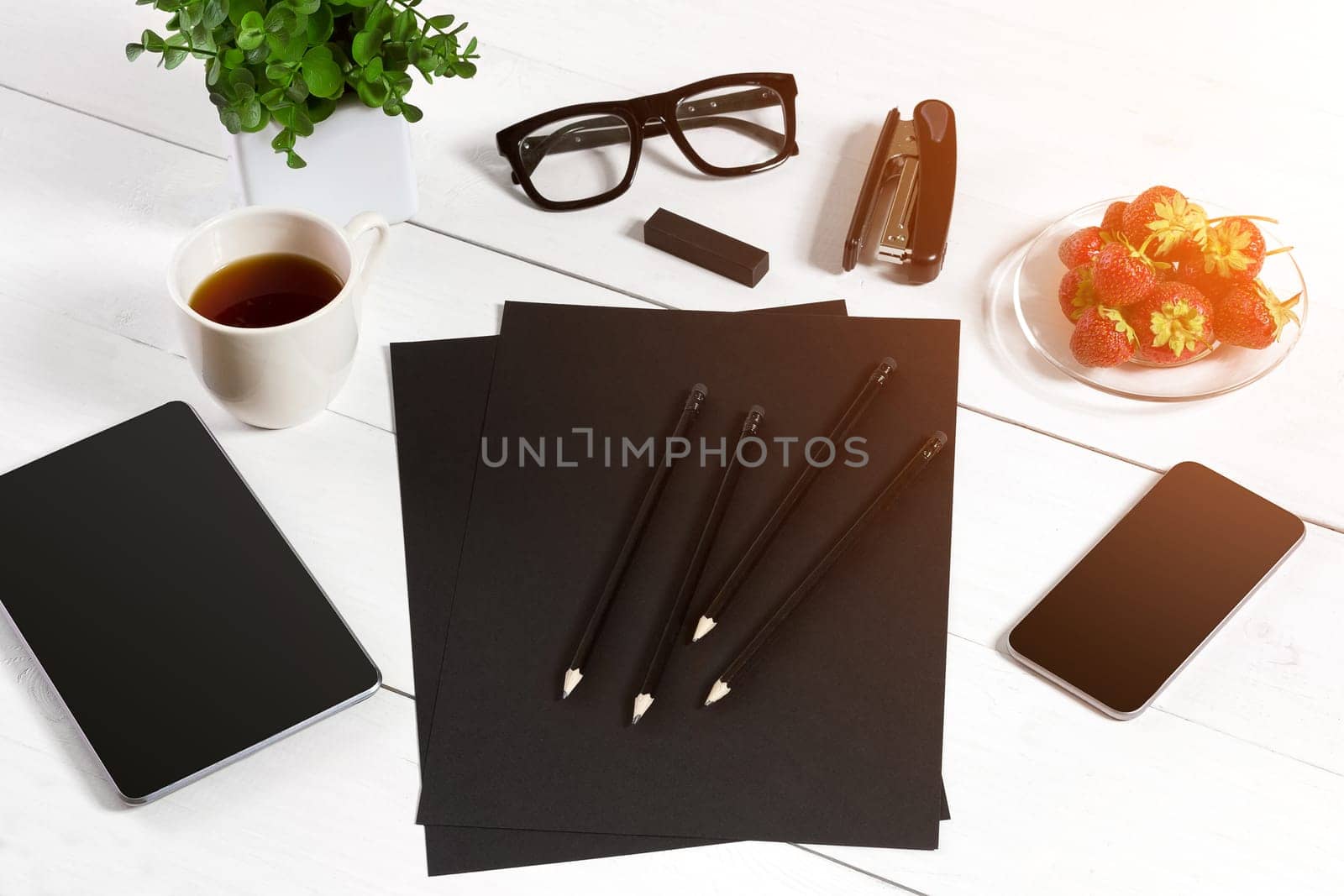 Modern workplace with digital tablet computer and mobile phone, cup of coffee, pen and empty sheet of paper. by nazarovsergey