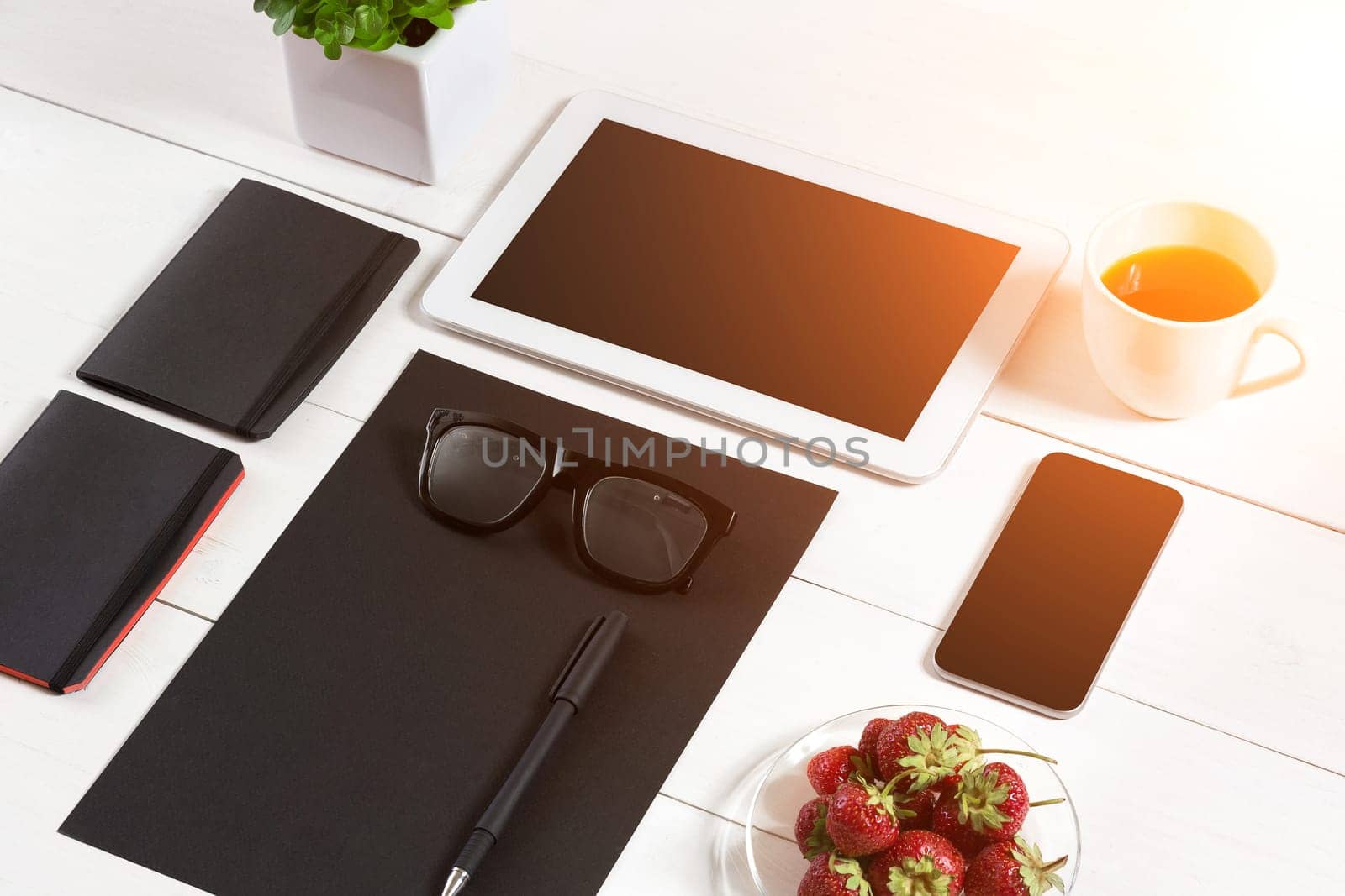 Modern workplace with digital tablet computer and mobile phone, cup of coffee, pen and empty sheet of paper. by nazarovsergey