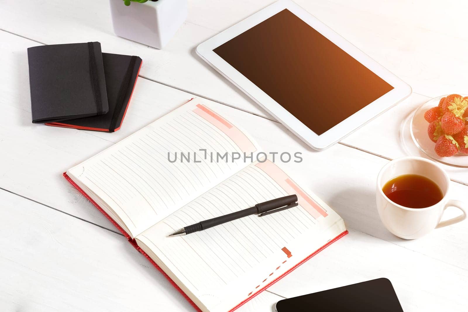 Stylish minimalistic workplace with tablet and notebook and glasses in flat lay style. White background. by nazarovsergey