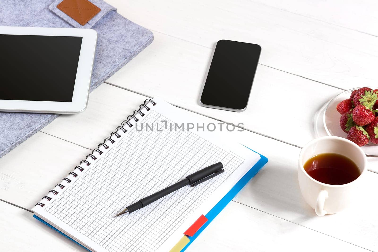 Stylish minimalistic workplace with tablet and notebook and glasses in flat lay style. White background. by nazarovsergey