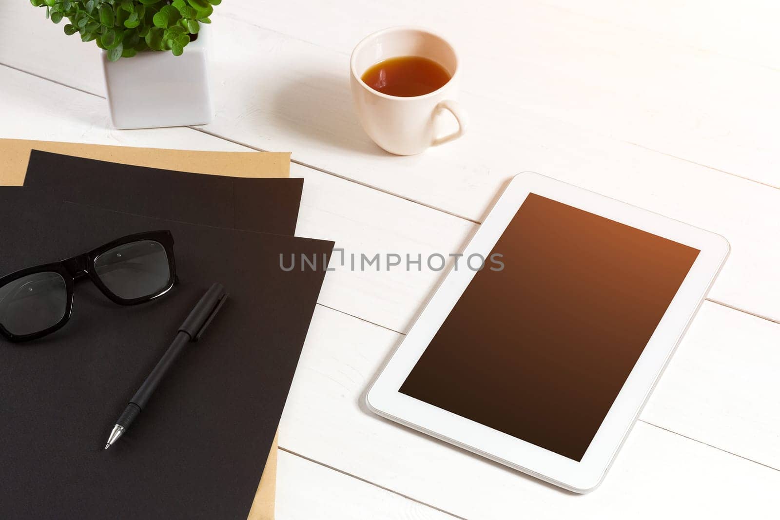 Modern workplace with digital tablet computer and mobile phone, cup of coffee, pen and empty sheet of paper. by nazarovsergey