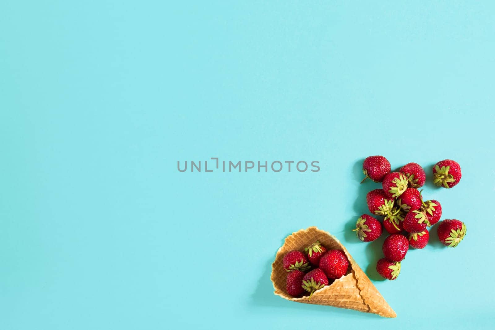 Fresh strawberry in waffle cone. Creative food concept. Flat lay by nazarovsergey