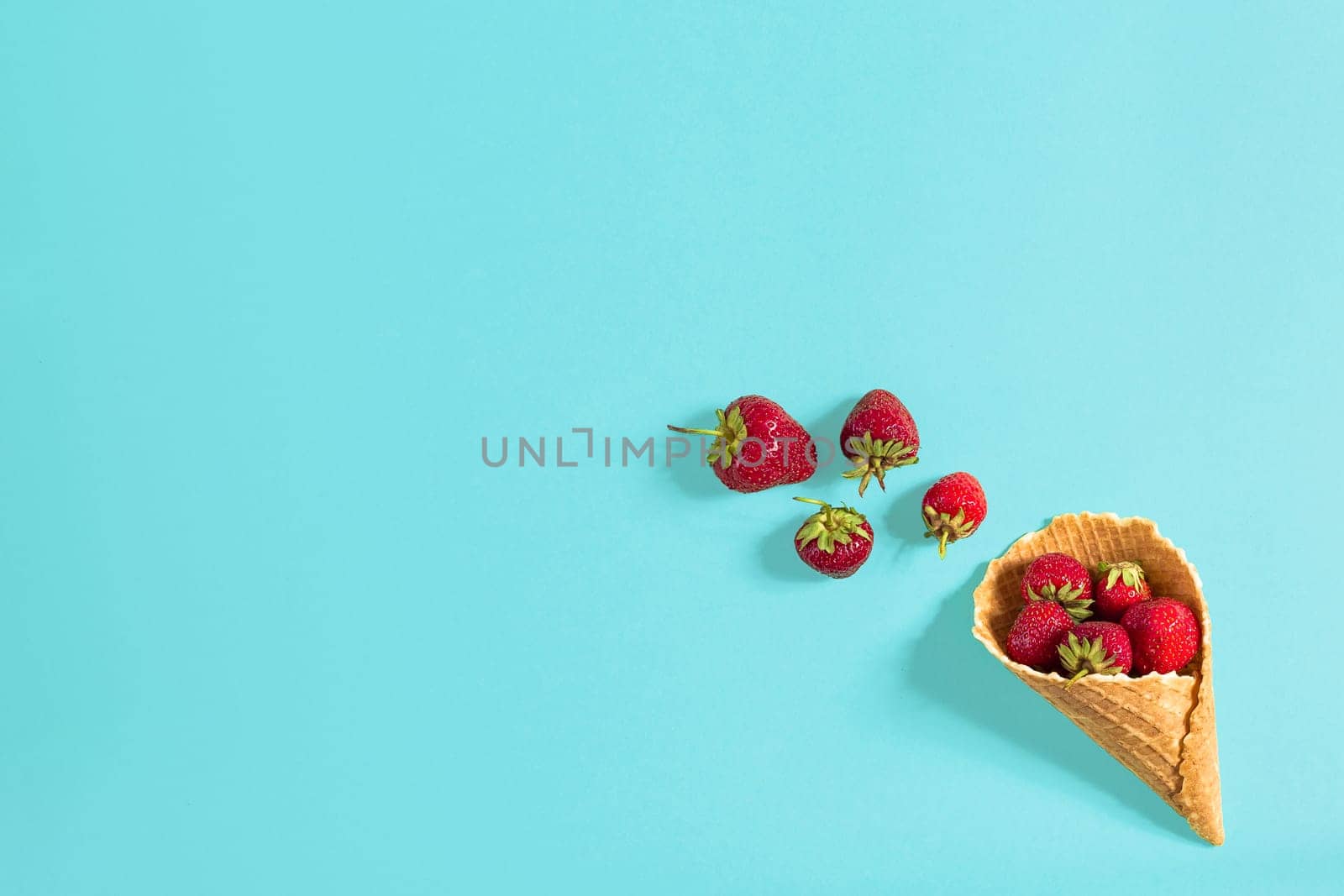 Fresh strawberry in waffle cone. Creative food concept. Flat lay, top view. Copy space. Still life mockup flat lay