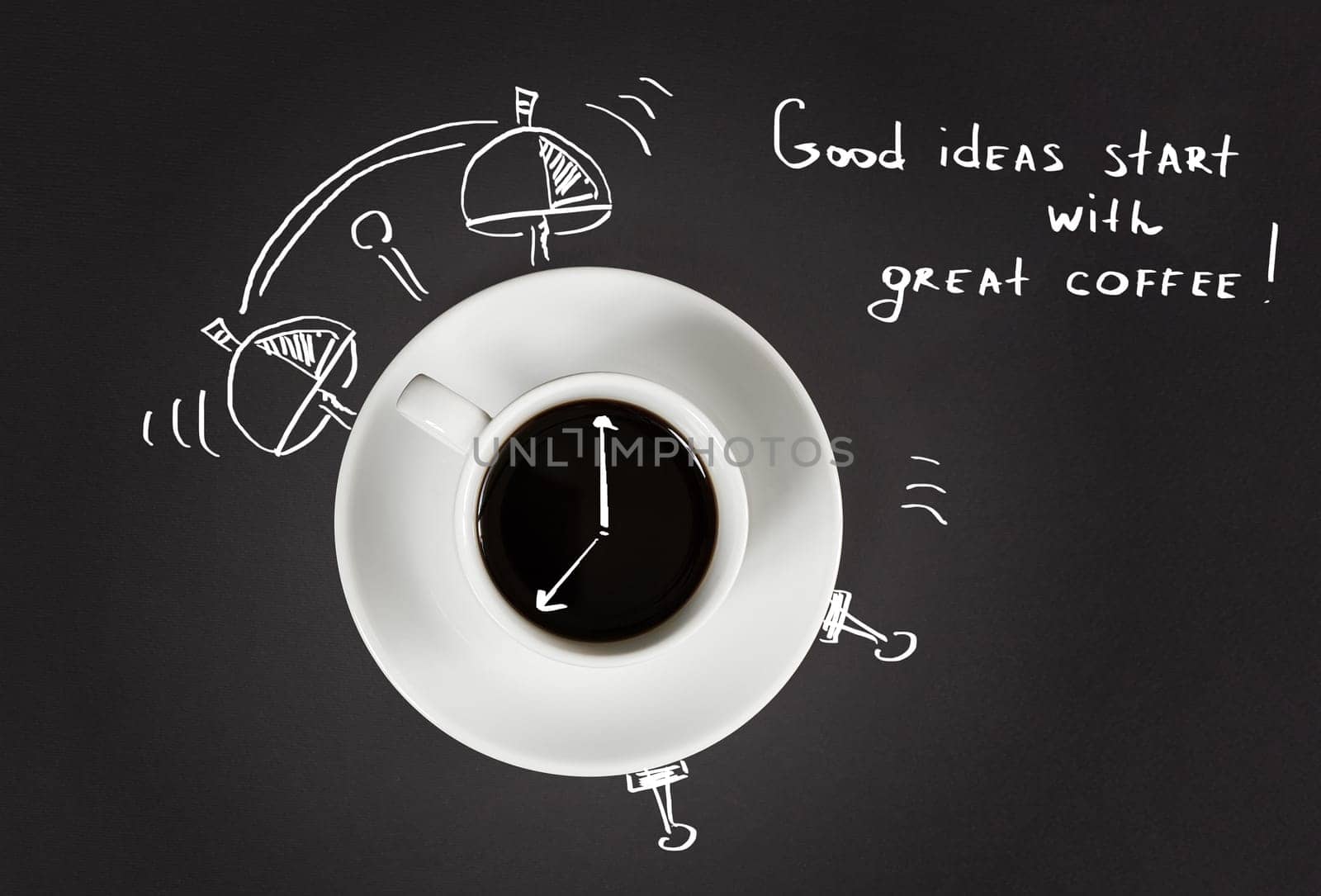 Good morning coffee and alarm clock concept on black slate background, top view