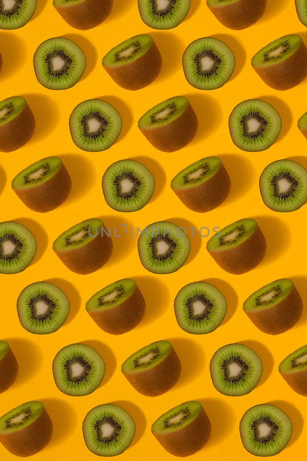 Colorful pattern of kiwi. Top view of the sliced kiwi. Kiwi on a yellow background