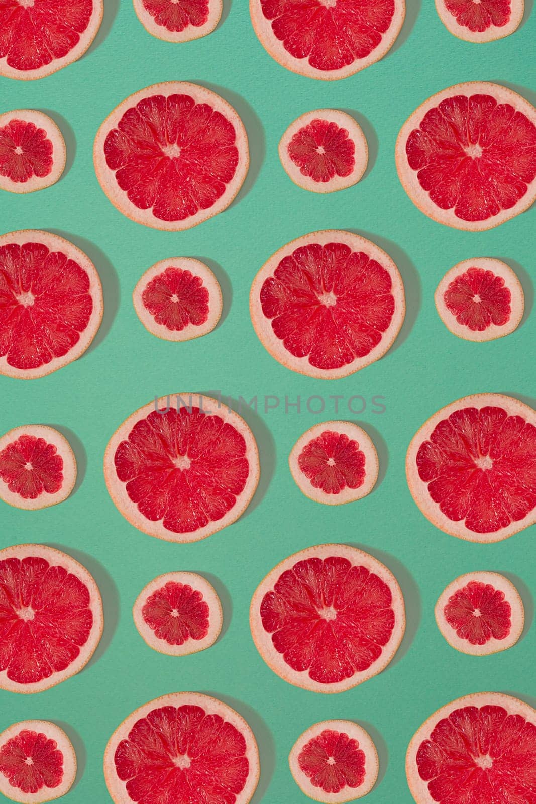 Grapefruit pattern isolated on blue background. Flat lay by nazarovsergey