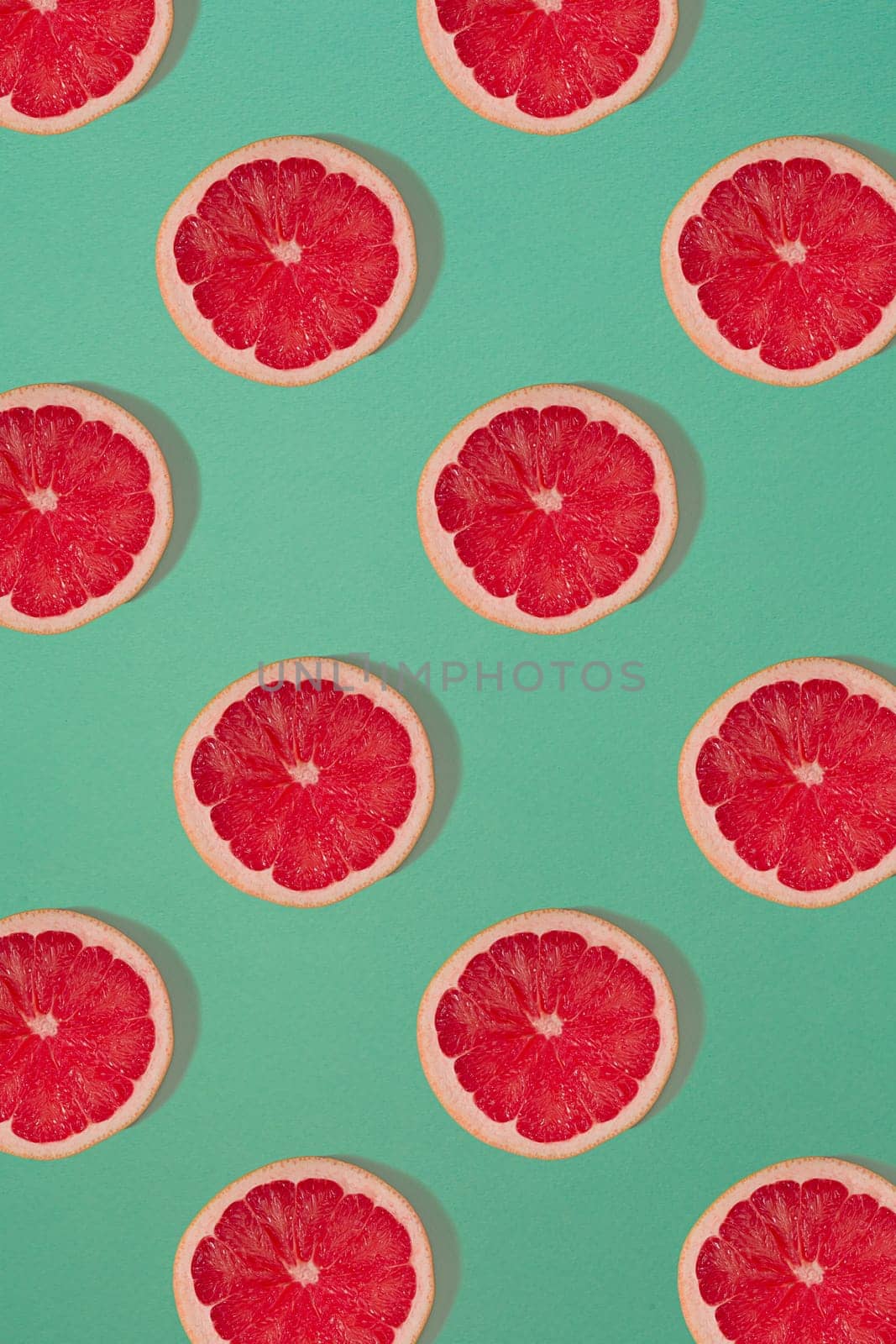 Grapefruit pattern isolated on blue background. Flat lay. Print