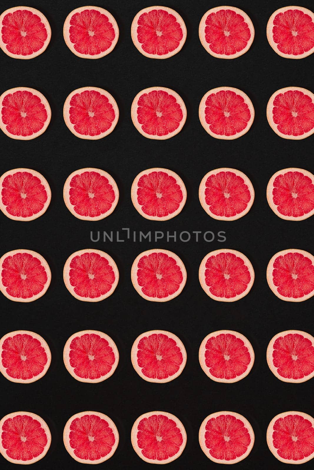 Grapefruit pattern isolated on black background. Flat lay by nazarovsergey
