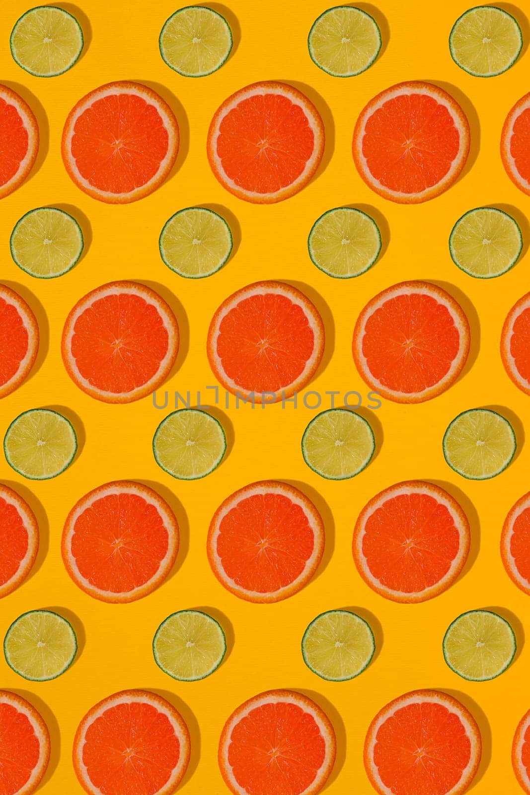 Grapefruit and lime pattern on yellow background. Minimal flat lay concept. Print