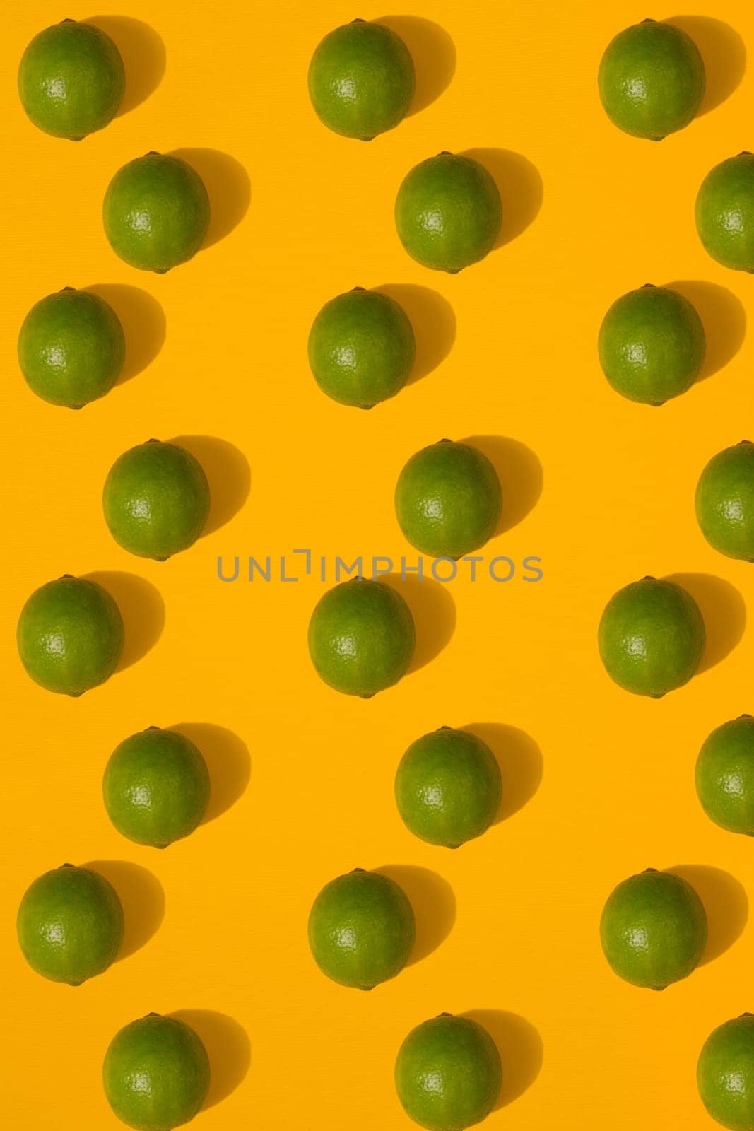 Lime pattern on yellow background. Minimal flat lay concept. Print