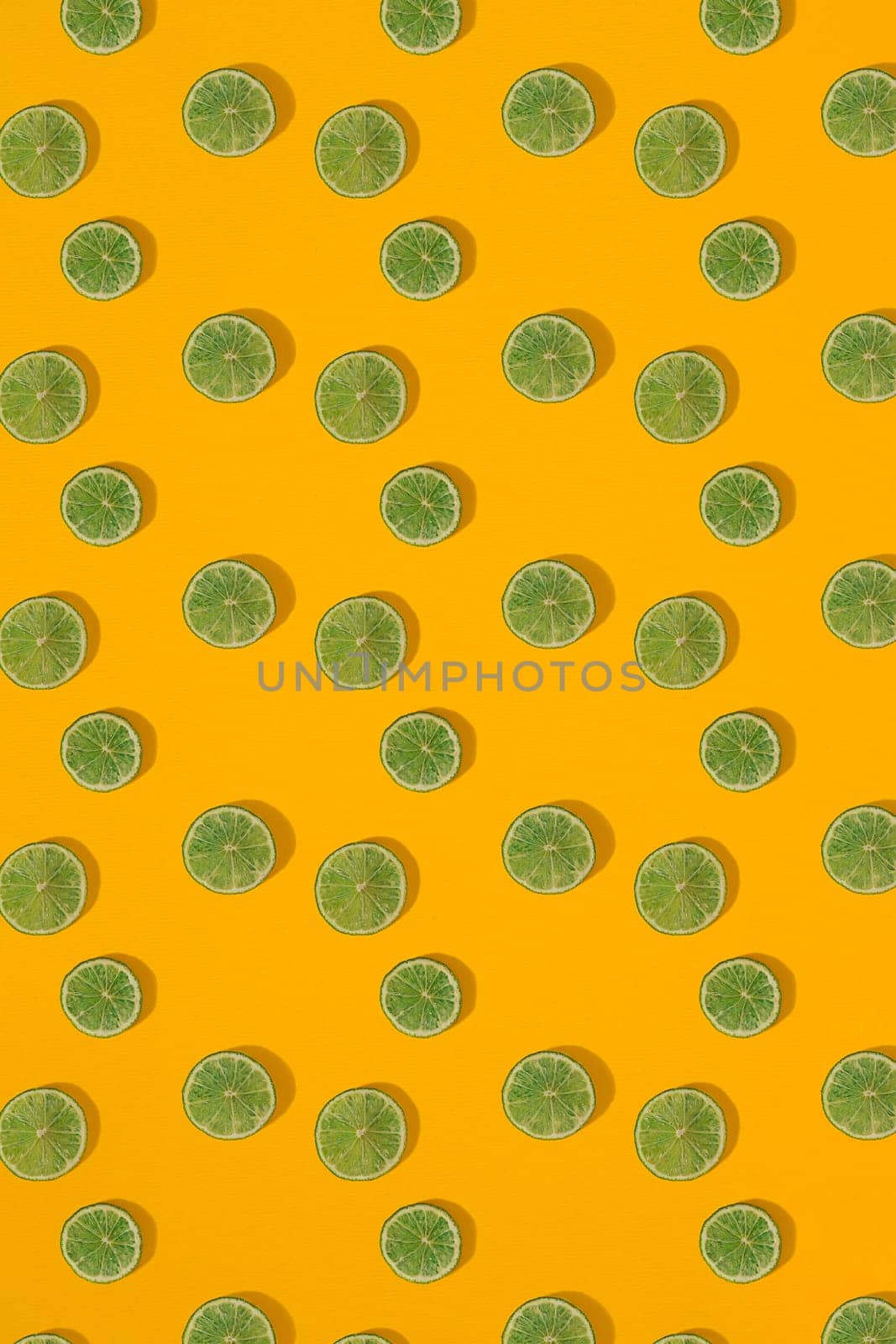 Lime pattern on yellow background. Minimal flat lay concept. Print