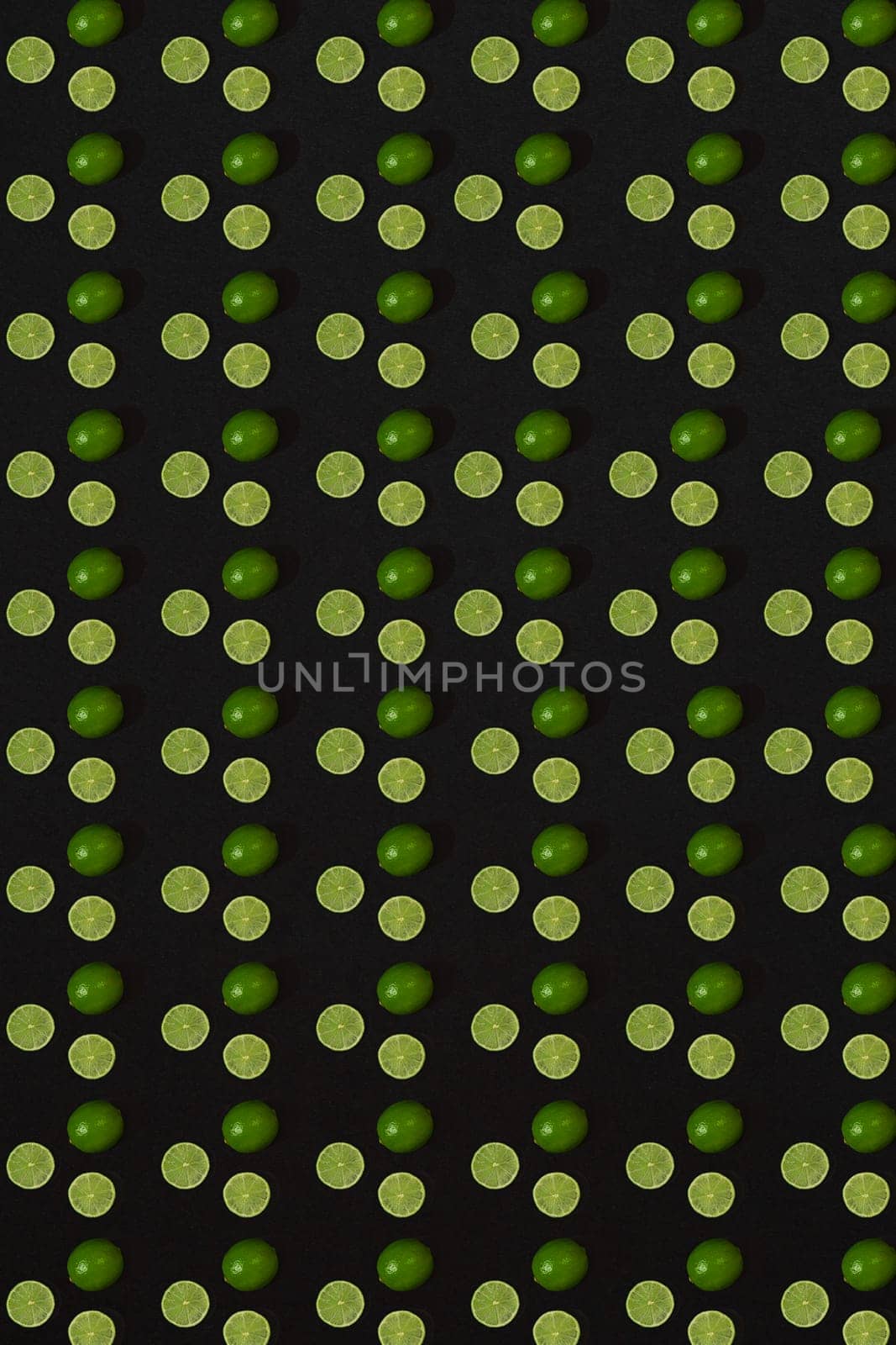 Lime pattern on black background. Minimal flat lay concept. Print