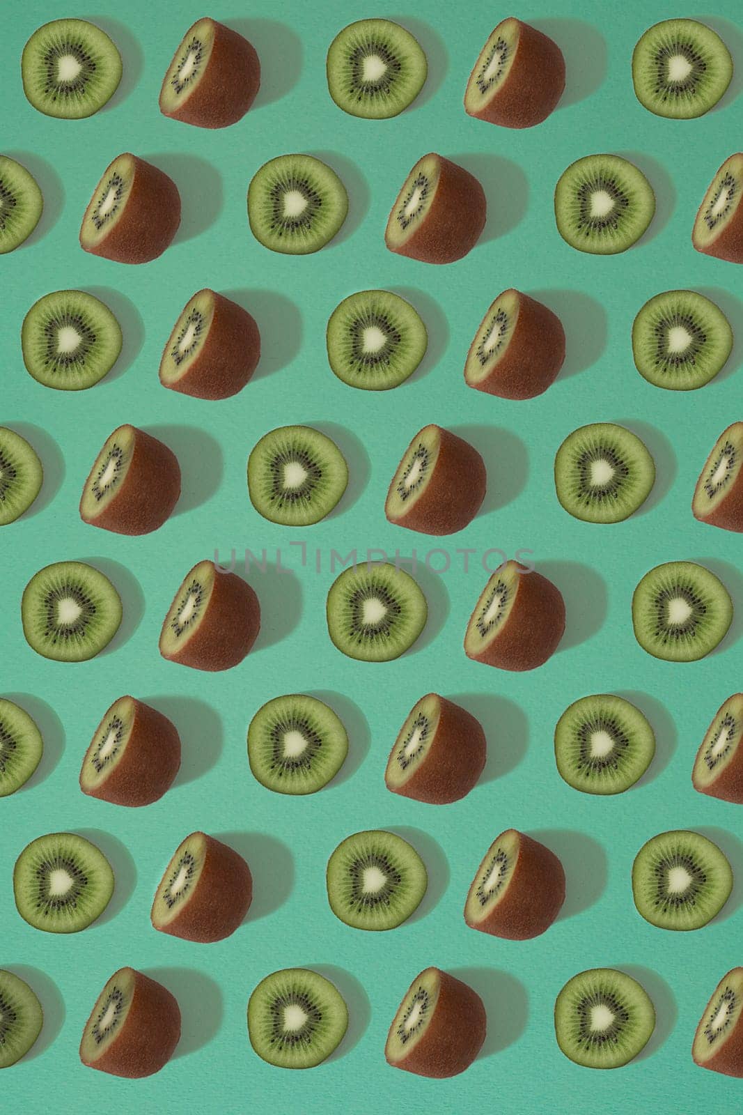 Pattern of kiwi. Top view of the sliced kiwi on blue background. Minimal flat lay concept. Print