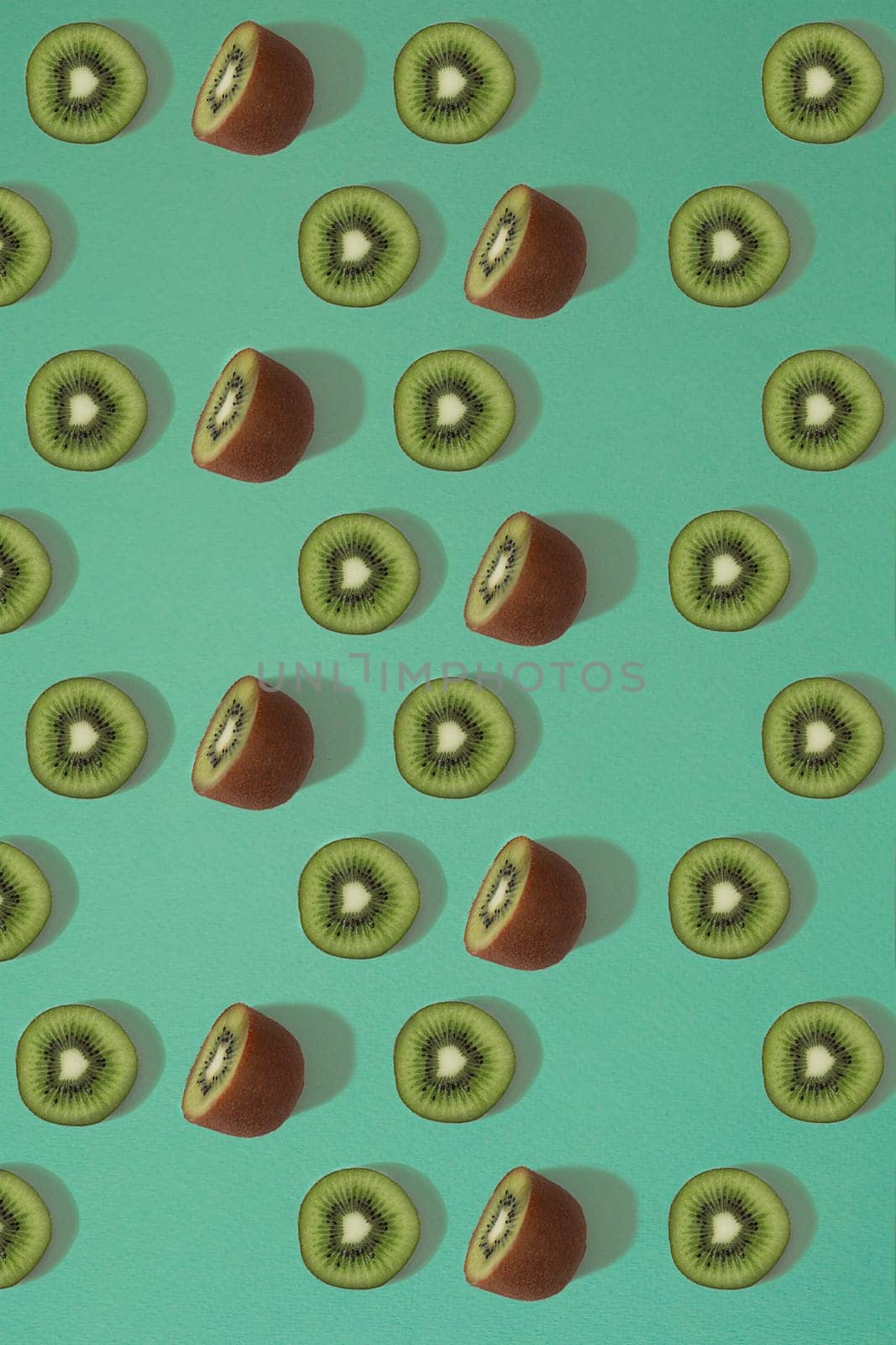 Pattern of kiwi. Top view of the sliced kiwi on blue background. Minimal flat lay concept. Print