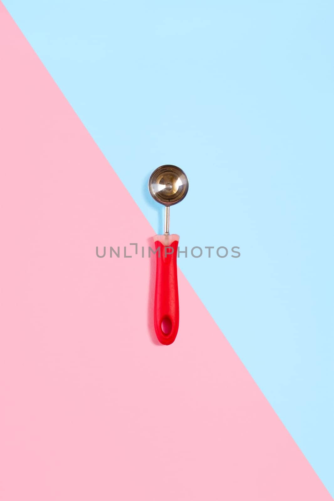 Ice cream scoop isolated on turquoise and pink. Top view. Copy space. Flat lay